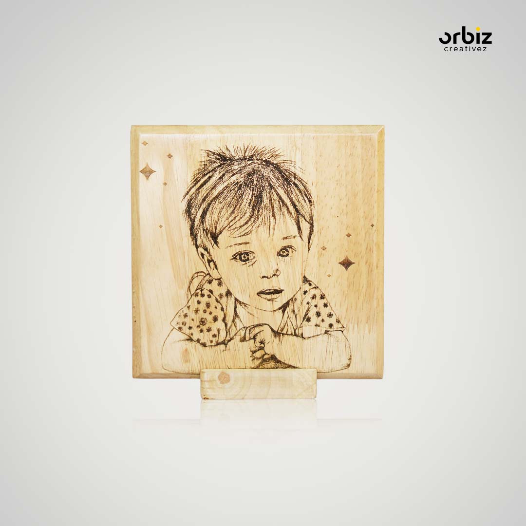 Close view of a child's face engraved in fine lines on rubwood